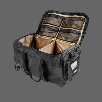 A red and black nylon firefighter gear bag with a telescoping handle, multiple interior pockets, and wheels for mobility.